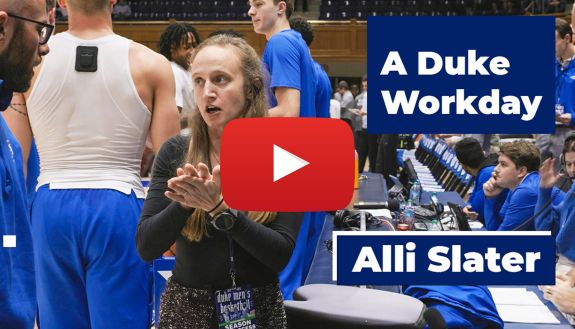 Alli Slater, Director of Game Operations & Championships for Duke Athletics, speaks to a co-worker inside Cameron Indoor Stadium